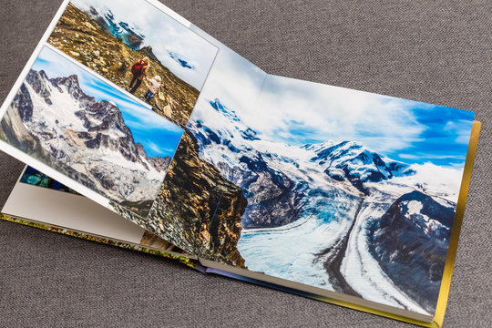 the photobook opened, travel in switzerland, on gray background