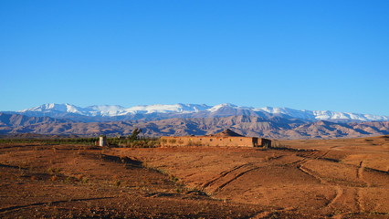 Bright landscape of Morocco, breathtaking curves of mountains, stunning combination of hills & farm land,inadvertent distribution of houses & huts, raw impression of pure nature.