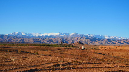 Bright landscape of Morocco, breathtaking curves of mountains, stunning combination of hills & farm land,inadvertent distribution of houses & huts, raw impression of pure nature.