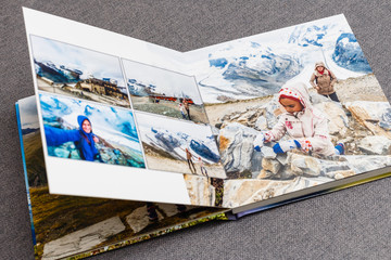 Fototapeta na wymiar the photobook opened, travel in switzerland, on gray background
