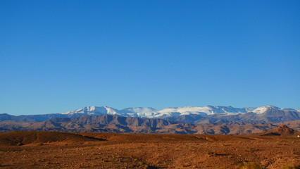 Bright landscape of Morocco, breathtaking curves of mountains, stunning combination of hills & farm land,inadvertent distribution of houses & huts, raw impression of pure nature.