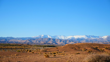 Bright landscape of Morocco, breathtaking curves of mountains, stunning combination of hills & farm land,inadvertent distribution of houses & huts, raw impression of pure nature.