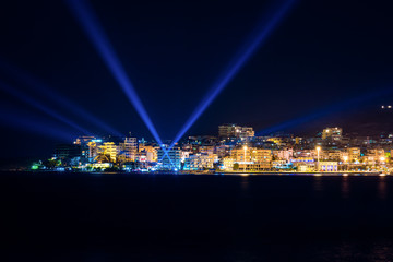 Naklejka na ściany i meble Night photo of Sarande in Albania in background with Mediterranean Sea on long exposure