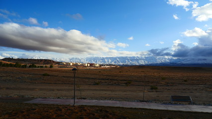 Bright landscape of Morocco, breathtaking curves of mountains, stunning combination of hills & farm land,inadvertent distribution of houses & huts, raw impression of pure nature.