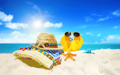Concept of summer beach holiday. Beach accessories - straw hat, glasses, towel, starfish, yellow...