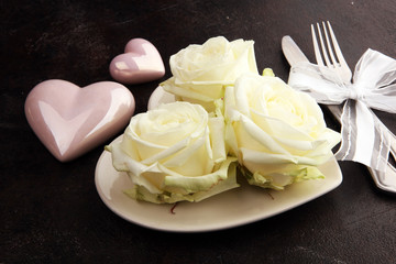 White rose on white dish. Meal on Valentines Day for the woman you love