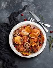 Baked chicken legs with garlic, orange and cranberry. Spicy bbq chicken legs