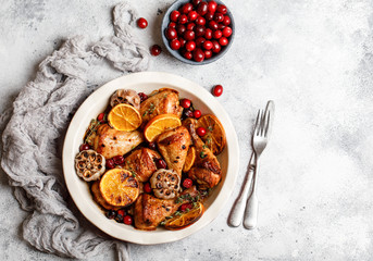 Baked chicken legs with garlic, orange and cranberry. Spicy bbq chicken legs