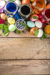 Easter organic and zero waste concept. Easter eggs painted with natural egg dye, fruits and vegetables. Wooden background