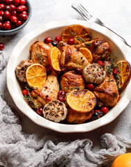 Baked chicken legs with garlic, orange and cranberry. Spicy bbq chicken legs