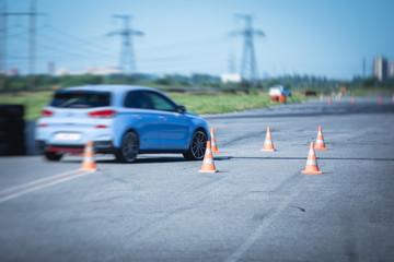 View of autodrome race circuit racetrack with a line of cars driving and racing, with audience and...