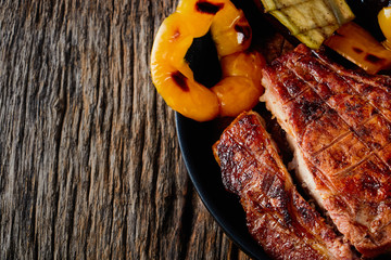Tomahawk steak with vegetables and a knife on the table.