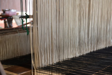 Local loom with fabric pattern on it.