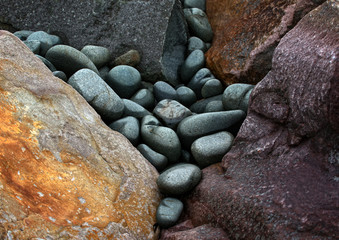 Bunte, runde, abgeschliffene Steine liegen am Strand 