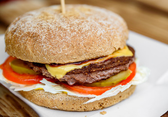burger closeup on wooden table. fast food
