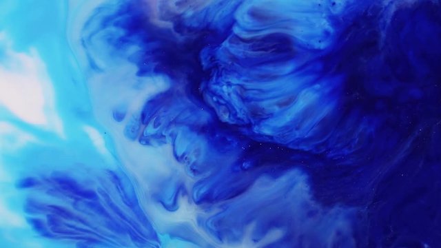 Fluid art painting with slow motion. Abstract texture artwork. Liquid background forms design. Mixed paint flow with acrylic fluid spreading. Blue and white colour flow animation