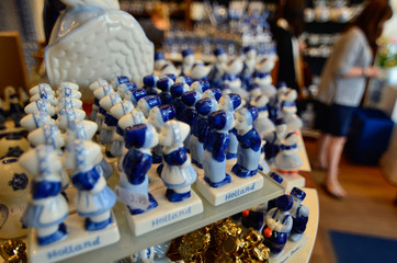 Delft, the netherlands, august 2019. The couple kissing at a shop of the famous white and blue ceramics: a very appreciated and famous souvenir.
