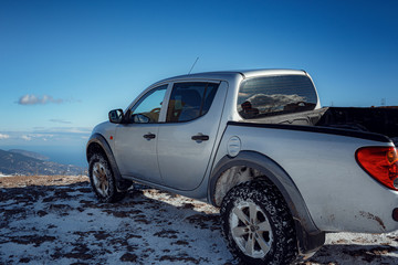 Pickup truck on road, Beautiful winter road under snow mountains. © Seleznov_Molchanova