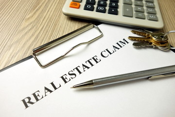Fototapeta premium Real estate claim form with pen keys and calculator