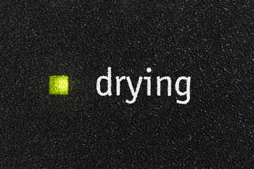Macro close up photograph of drying indicator light on dishwasher machine. 