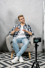Young adult vlogger creating video content for media website