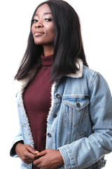 Fashion shoot of afro-american model wearing jeans jacket and burgundy golf silted on white background.