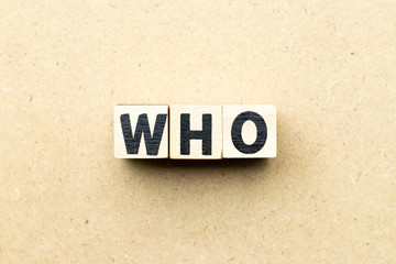 Letter block in word who on wood background