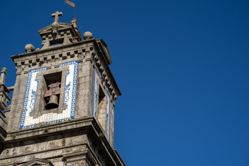Fototapeta na wymiar Exterior of the Church of Saint Ildefonso in Porto, Portugal on a sunny day - on the bell tower