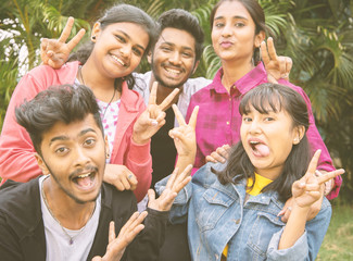 Young teenage friends taking selfie with funny faces - Concept of youth happy friendship having fun together - Millennials of selfie generation.