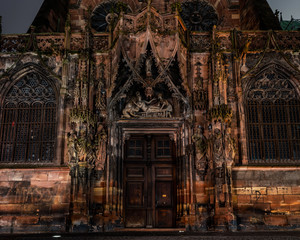 Fototapeta premium The side facade of the Cathedral in Strasbourg, richly decorated with sculptural compositions