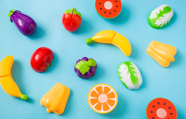 Plastic food children's toys on a blue background. The concept of healthy eating, nutrition for...