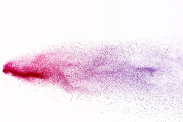 Freeze motion of purple color powder exploding on white background.