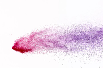Freeze motion of purple color powder exploding on white background.