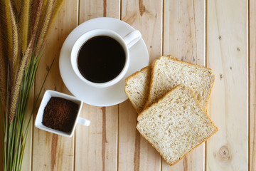 Coffee cup and bread on the table in the morning