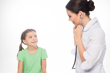 Smiling child looking at pediatrician with stethoscope isolated on white