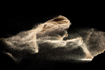 Fototapeta na wymiar Dry river sand explosion isolated on black background. Abstract sand cloud.Brown colored sand splash.