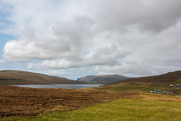 Beautiful meadows and lake in the mountains of the Faroe Islands