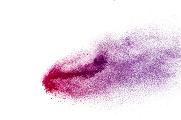 Freeze motion of purple color powder exploding on white background.
