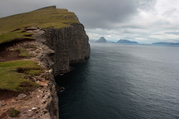 High cliff into the ocean. Location - Faroe Islands