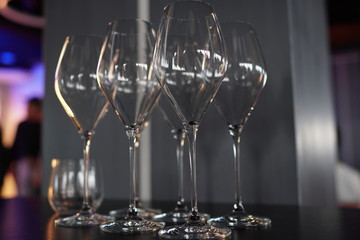 Set of empty transparent glasses on a table at a restaurant party.