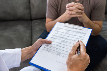 Doctor explaining for patient and showing medical records informations and diagnosis patient symptoms in a consultation and medical insurance concept.