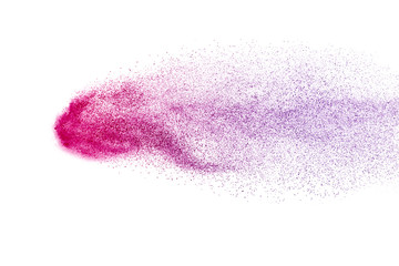 Freeze motion of purple color powder exploding on white background.