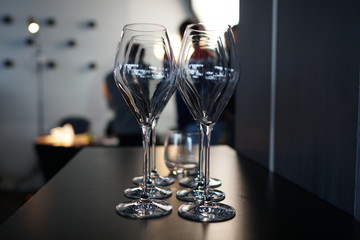 Set of empty transparent glasses on a table at a restaurant party.