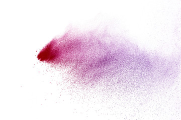 Freeze motion of purple color powder exploding on white background.