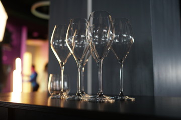 Set of empty transparent glasses on a table at a restaurant party.