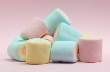 Fototapeta na wymiar colorful marshmallows candy on pink background