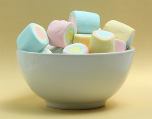 colorful marshmallows candy  on yellow background