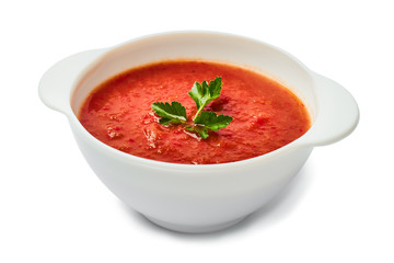 Tomato soup in a white bowl isolated on white background