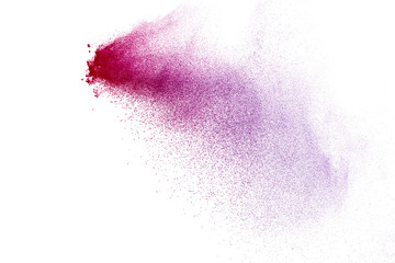 Freeze motion of purple color powder exploding on white background.