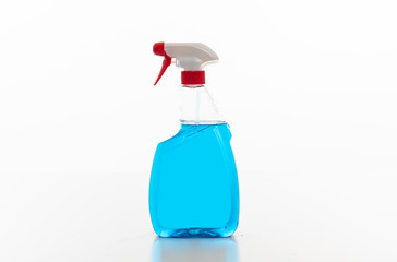 Cleaning spray bottle clear with blue color fluid isolated against white background.